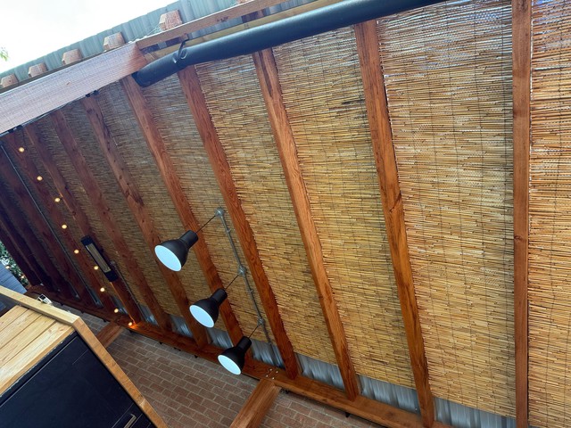 Bamboo roof covering, hiding foil covered bubble wrap